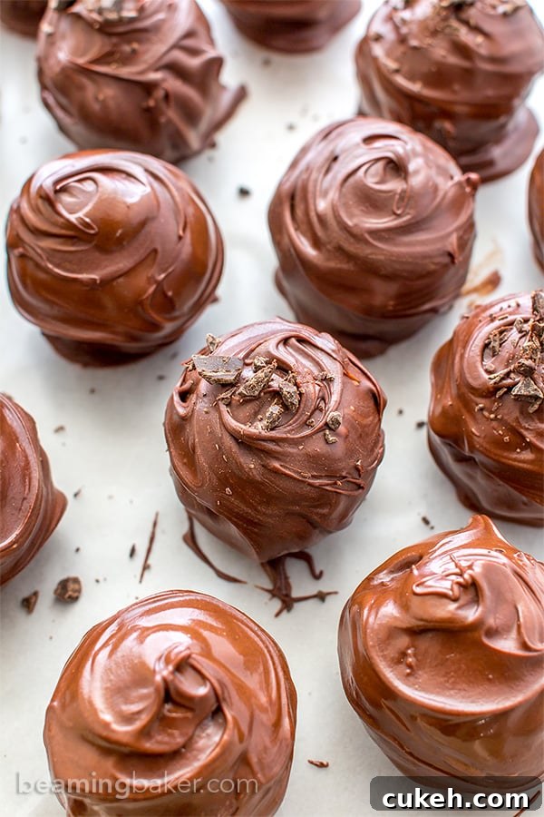 Chocolate Chip Cookie Dough Truffles (V+GF): Decadent cookie dough centers studded with chocolate chips and encased in a smooth, dark chocolate shell. BEAMINGBAKER.COM. #Vegan #GlutenFree