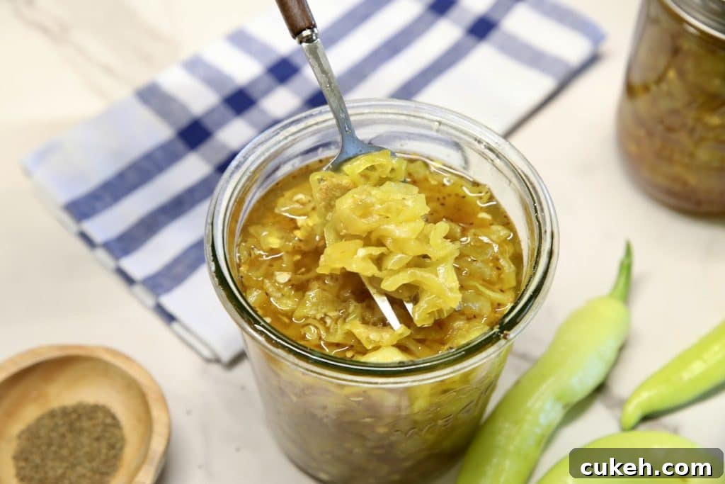 Jar of candied peppers with fork.
