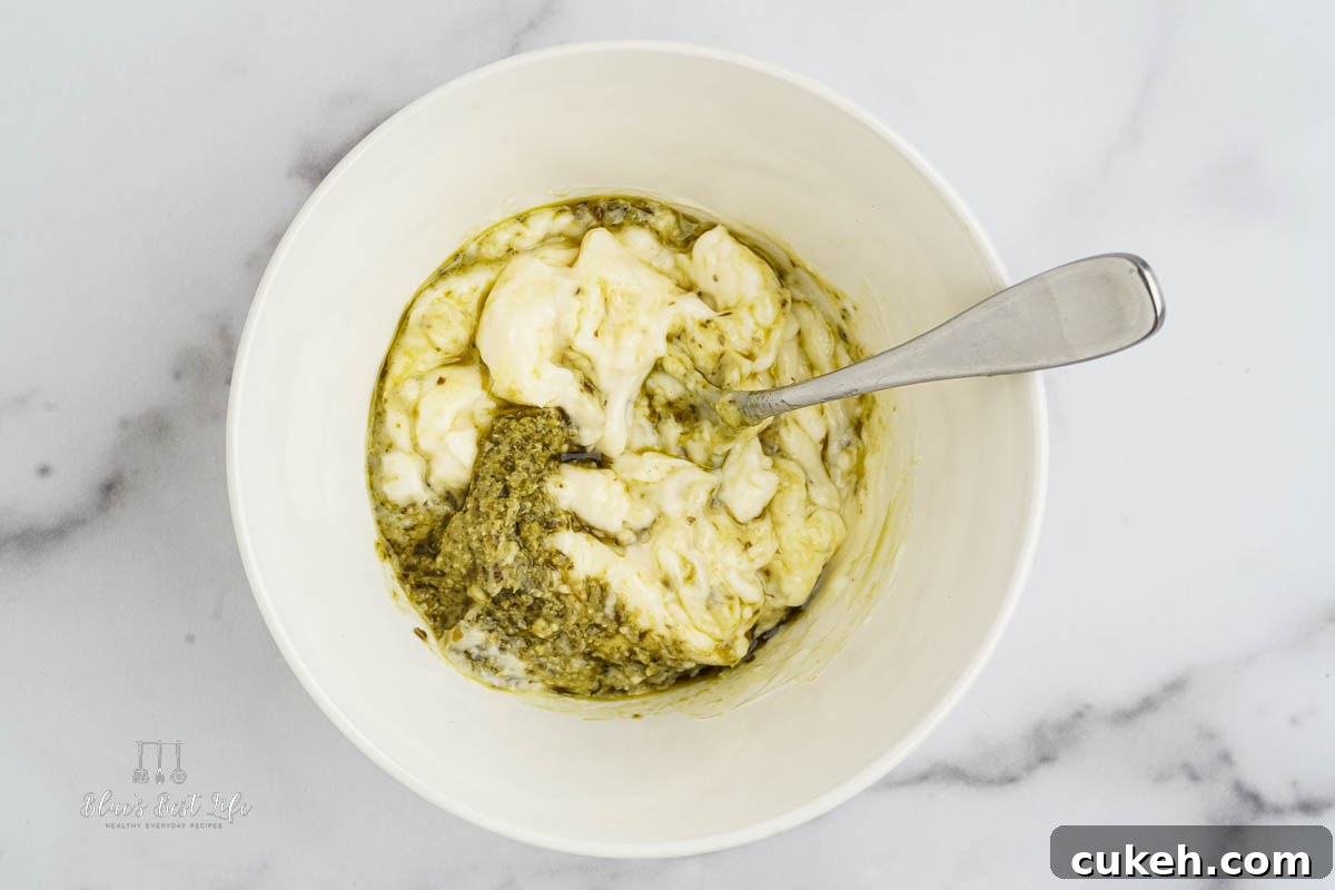 mixing together the pesto and mayo