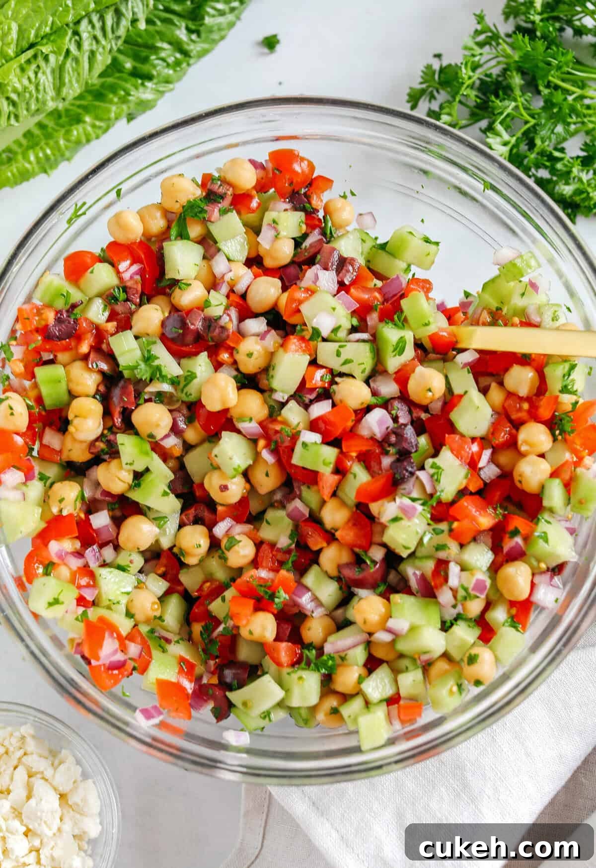 Fresh and crisp Mediterranean Chopped Salad made with fresh tomatoes, crisp cucumbers, red onion, chickpeas, olives and feta cheese all tossed with a delicious red wine vinaigrette!