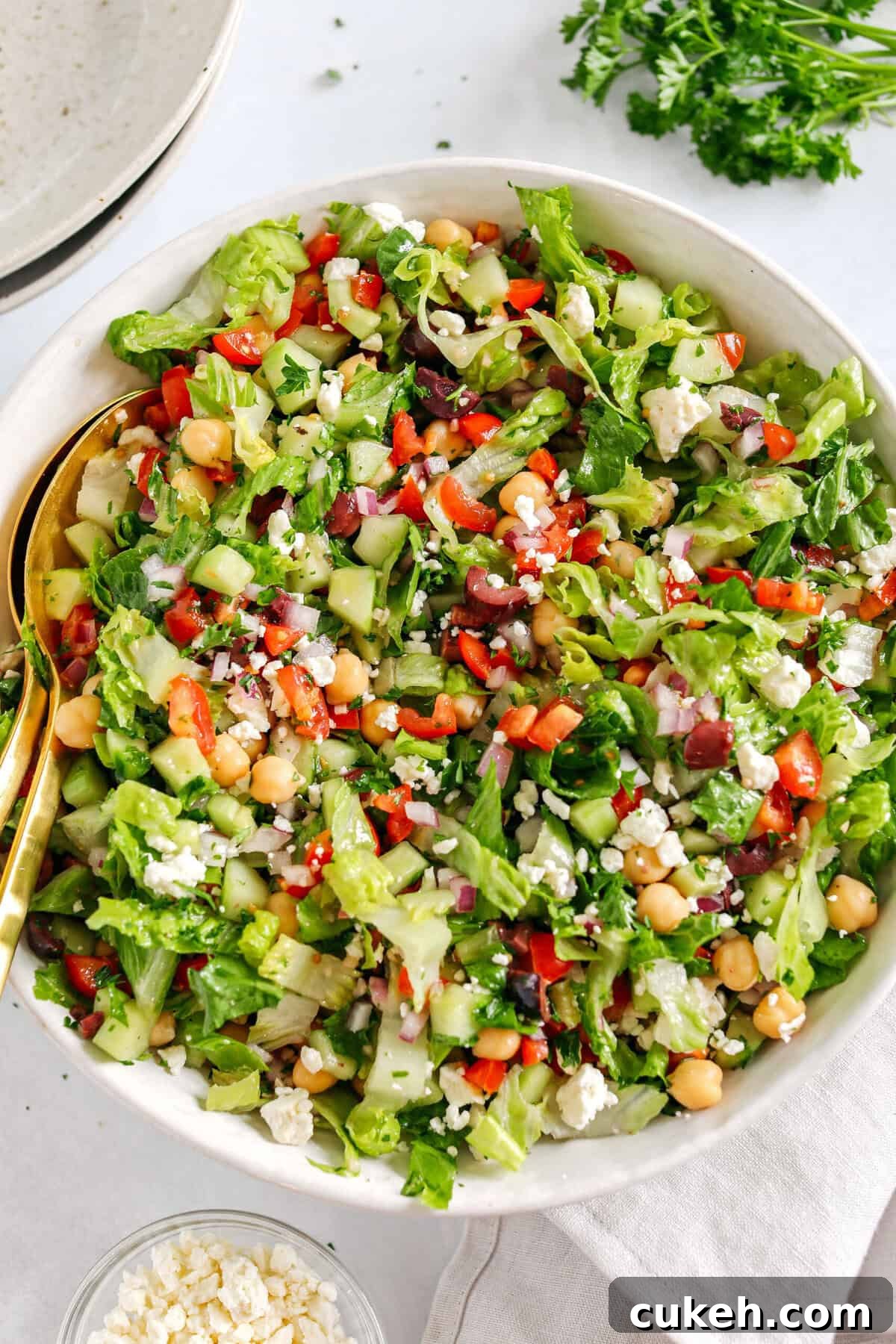 Fresh and crisp Mediterranean Chopped Salad made with fresh tomatoes, crisp cucumbers, red onion, chickpeas, olives and feta cheese all tossed with a delicious red wine vinaigrette!