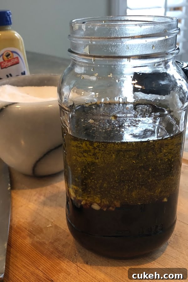 Savory Balsamic Steak Marinade for Tender, Flavorful Grilling 2 A mason jar filled with ingredients for balsamic steak marinade.