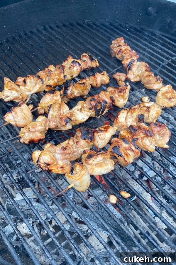 Savory Balsamic Steak Marinade for Tender, Flavorful Grilling 4 Grilling marinated chicken skewers on a charcoal grill.
