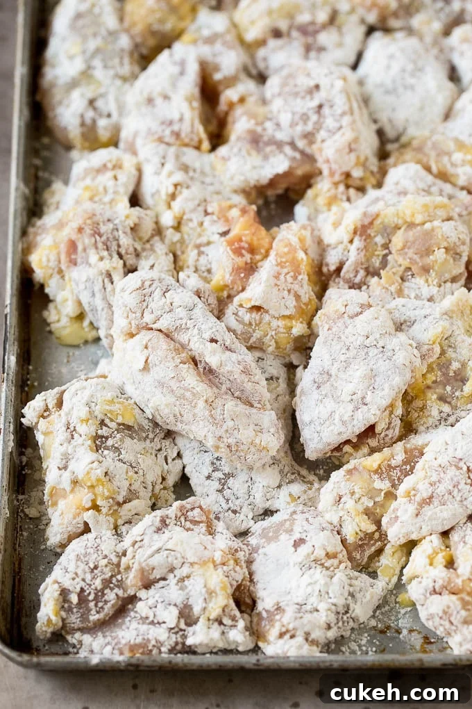 Chicken thigh pieces coated in egg, flour and cornstarch.