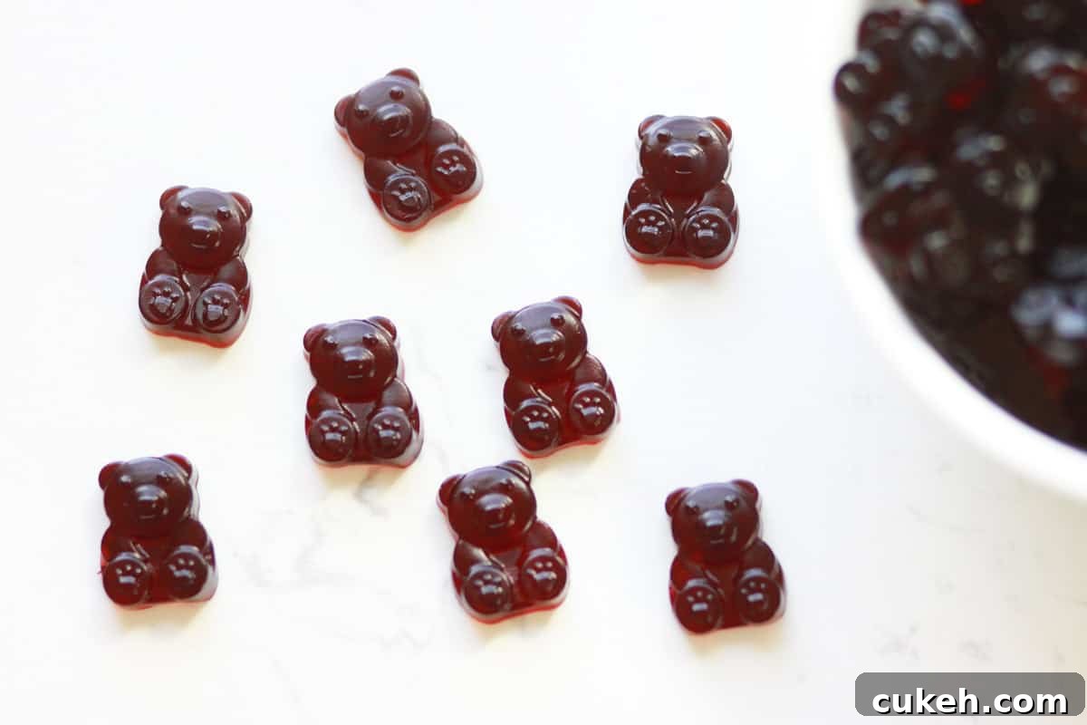 a bowl of dark red cherry gummies with some spilled out