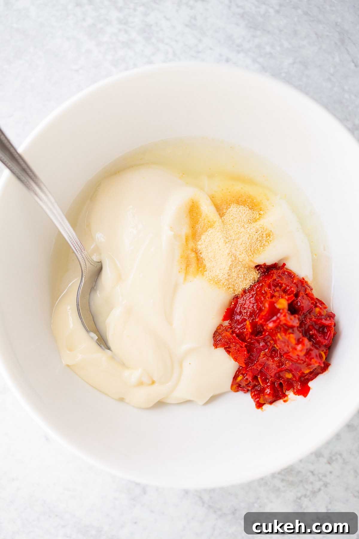 Ingredients for harissa mayo in a bowl