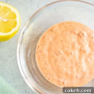 Harissa mayo in a bowl with a lemon on the side