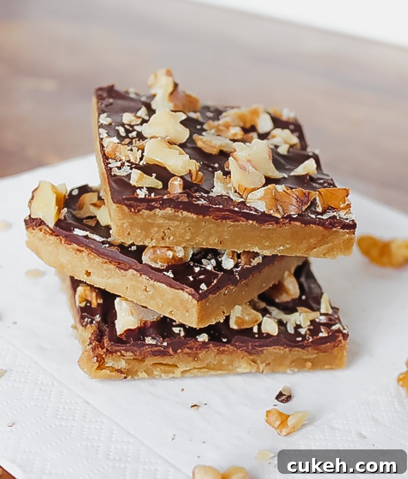 three toffee bars with chocolate stacked on top of each other