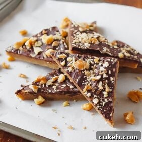 toffee triangles on parchment paperwith broken pies of nuts on top