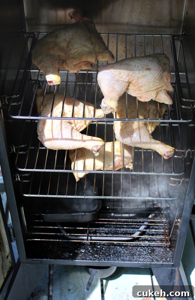 Coca Cola Leg Quarters smoking in vertical smoker