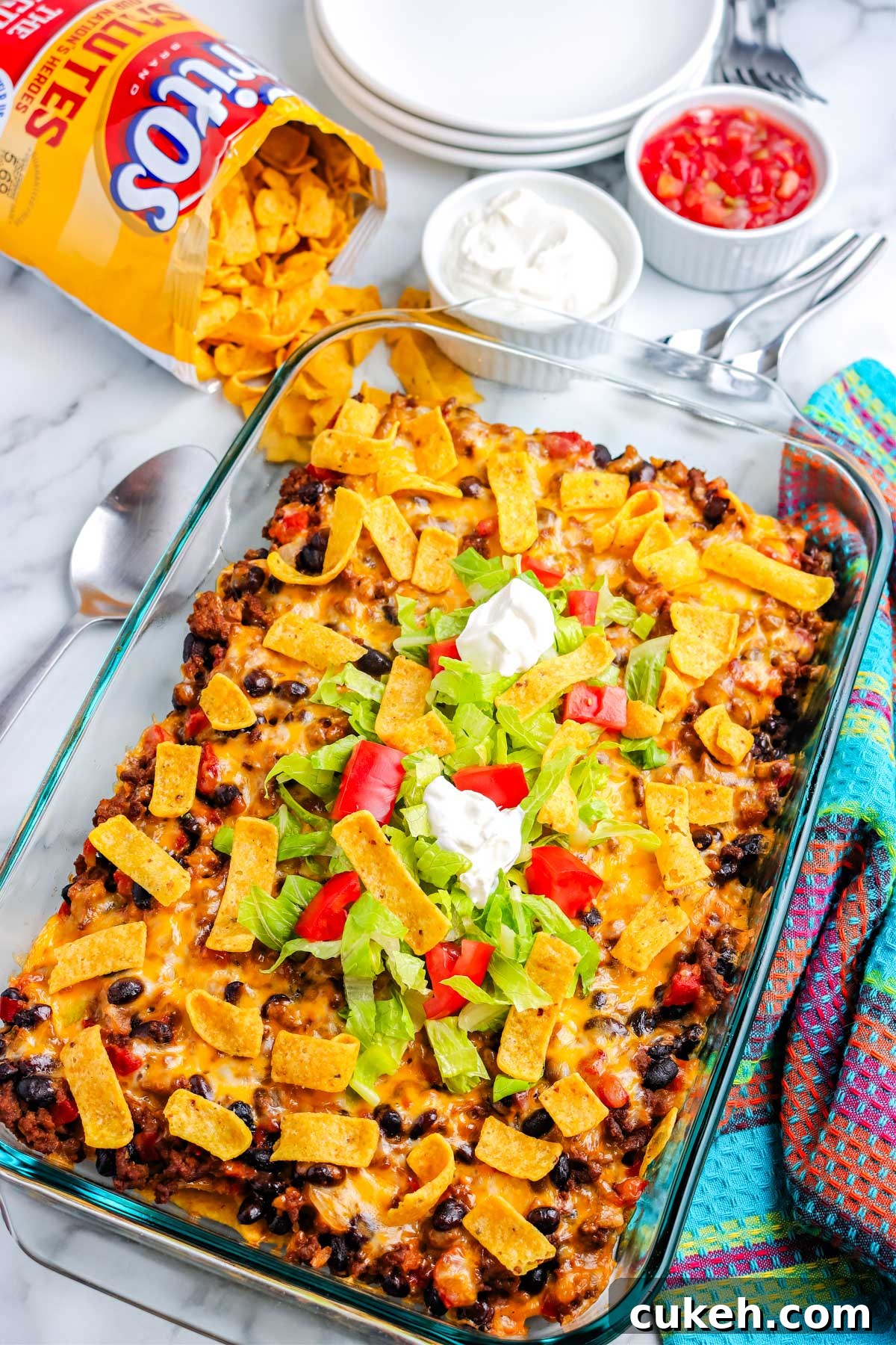 The finished walking taco casserole garnished with toppings. 