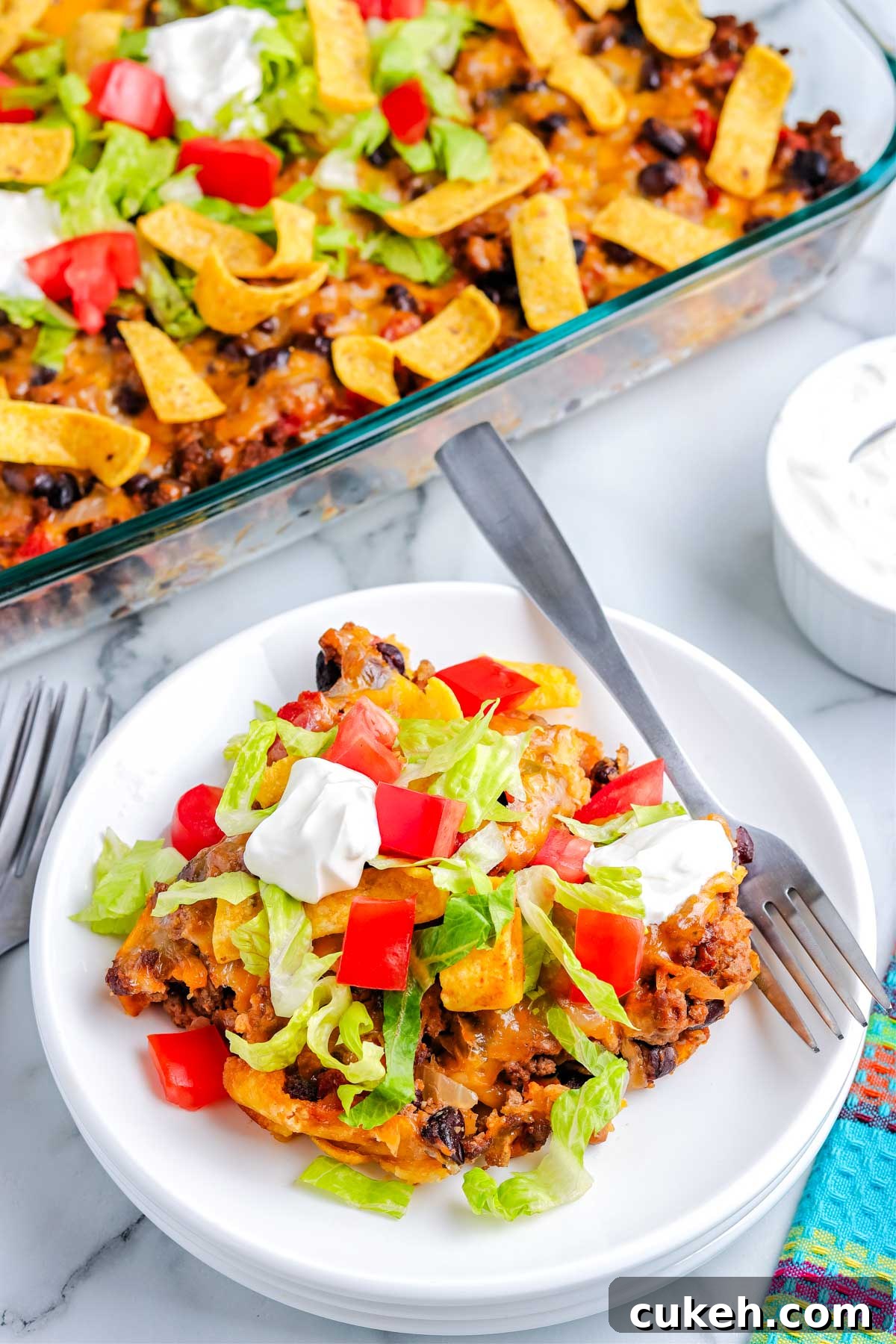 Walking taco casserole on a white plate.