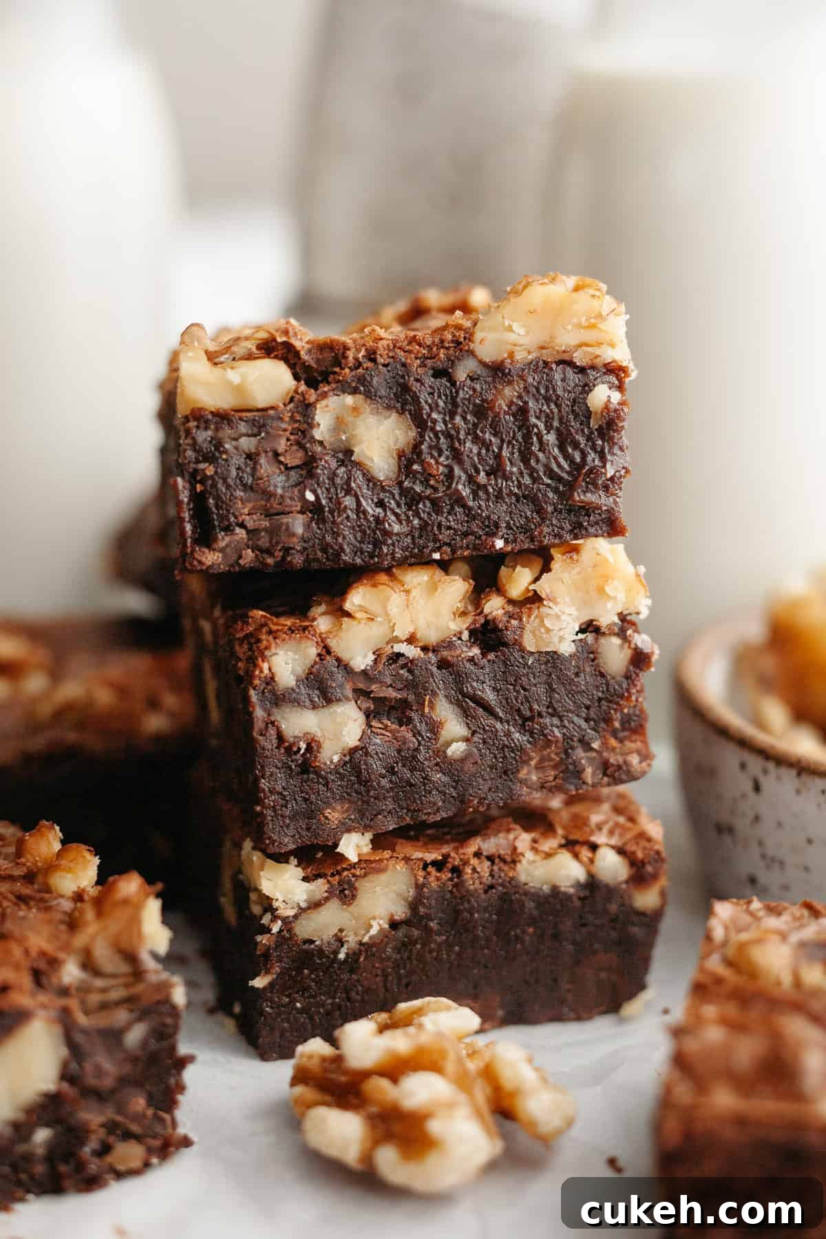 A stack of three fudgy walnut brownies.
