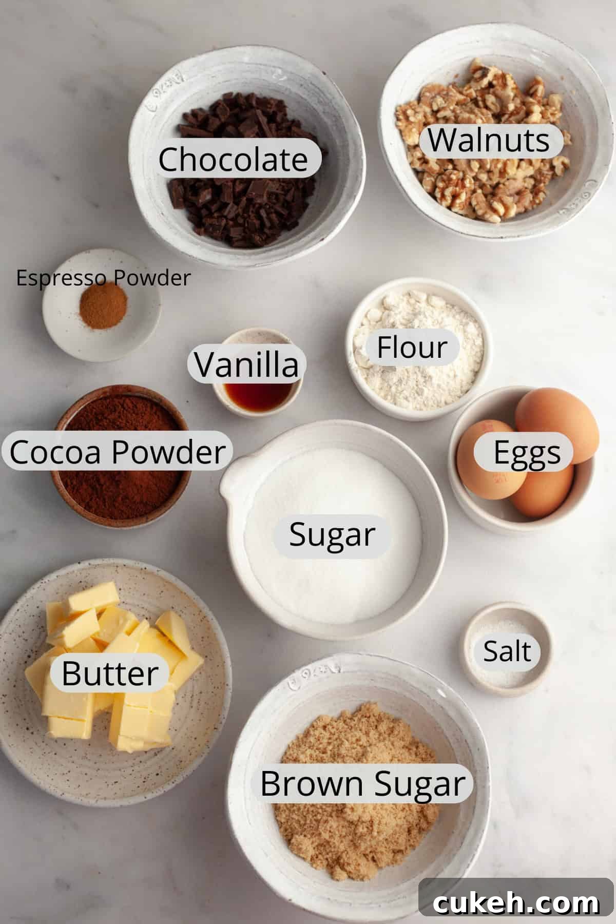 All the ingredients needed to make walnut brownies, weighed out into small bowls.