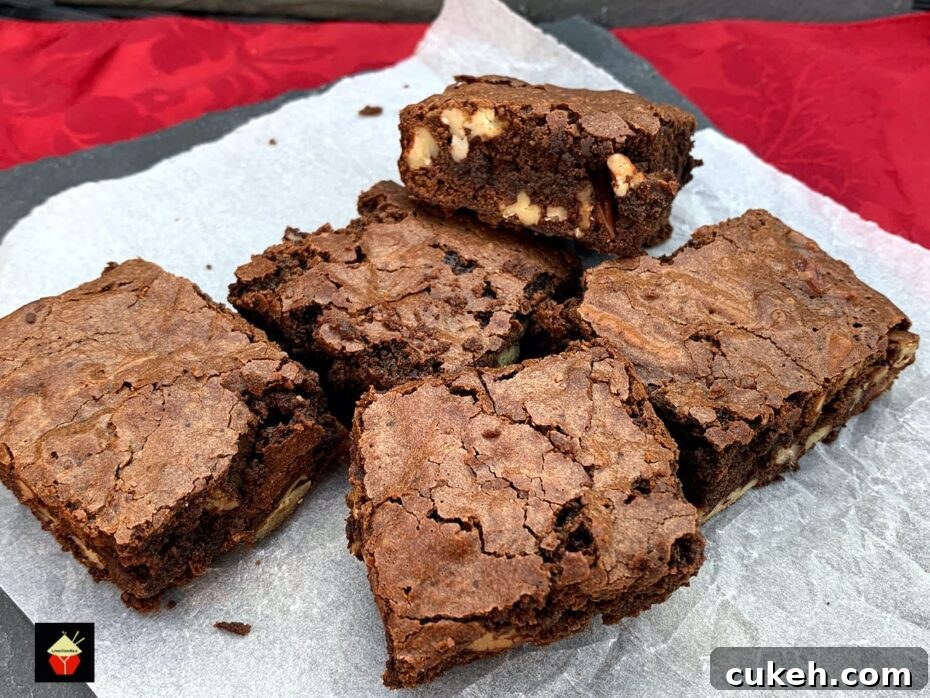 Triple Chocolate Pecan Brownies. These chewy soft brownies have a classic crisp outer, loaded with chocolate and pecan nuts. A sinfully rich chocolate dessert perfect for chocolate lovers