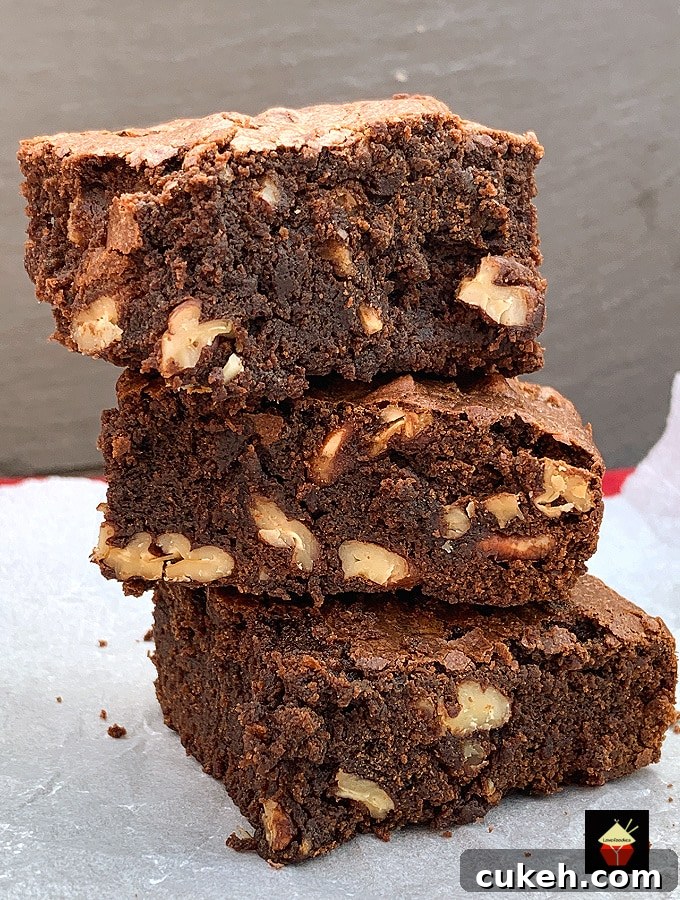 Triple Chocolate Pecan Brownies. These chewy soft brownies have a classic crisp outer, loaded with chocolate and pecan nuts. A sinfully rich chocolate dessert perfect for chocolate lovers