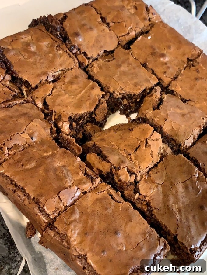 Triple Chocolate Pecan Brownies. These chewy soft brownies have a classic crisp outer, loaded with chocolate and pecan nuts. A sinfully rich chocolate dessert perfect for chocolate lovers