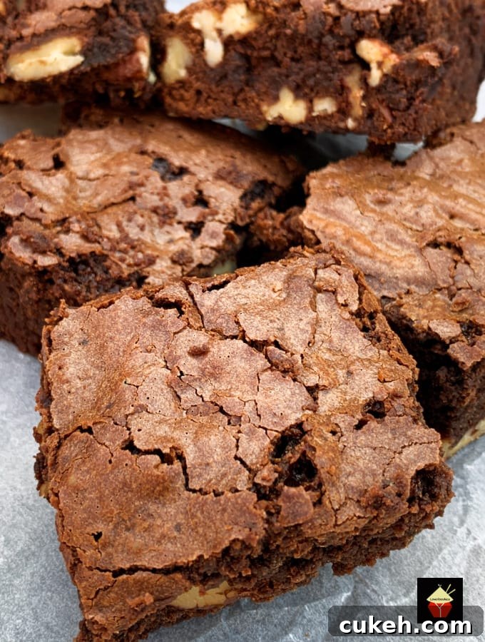 Triple Chocolate Pecan Brownies. These chewy soft brownies have a classic crisp outer, loaded with chocolate and pecan nuts. A sinfully rich chocolate dessert perfect for chocolate lovers