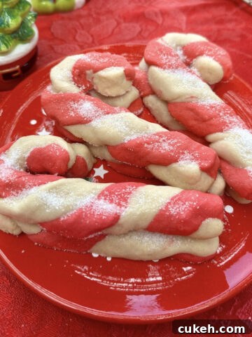 Christmas candy cane cookies stacked on a plate.