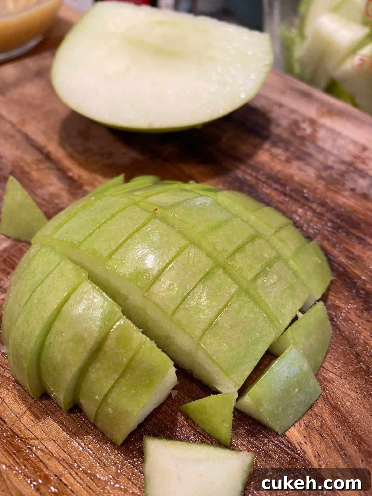 One half of an apple, skin side up and diced into small portions.