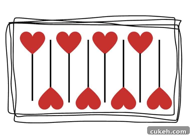 Pattern of cookies on a baking tray, one facing up, one facing down, repeating in this pattern.