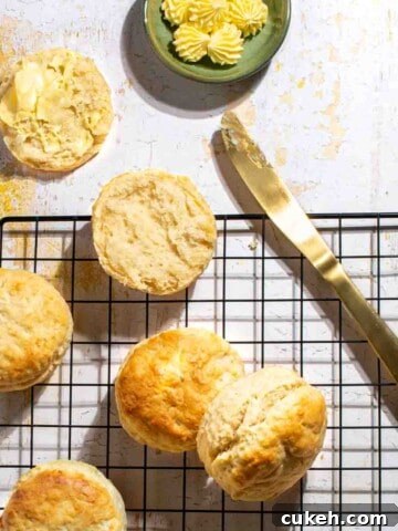 3-Ingredient scones on a black wire rack, served with some butter.