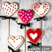 Five valentine's sugar biscuits on sticks.