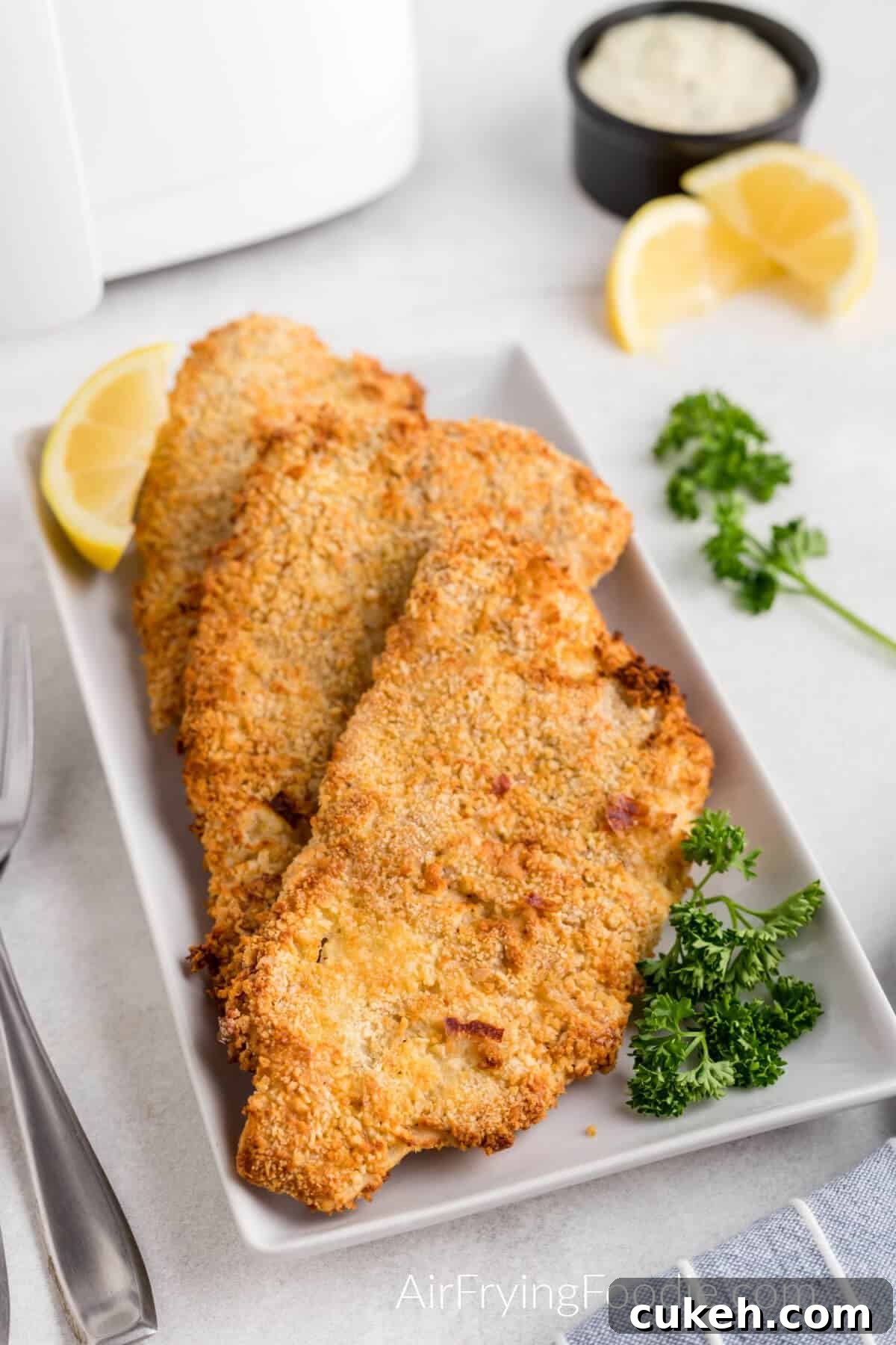 leftover Fish reheated in the air fryer and then served on a white plate. 