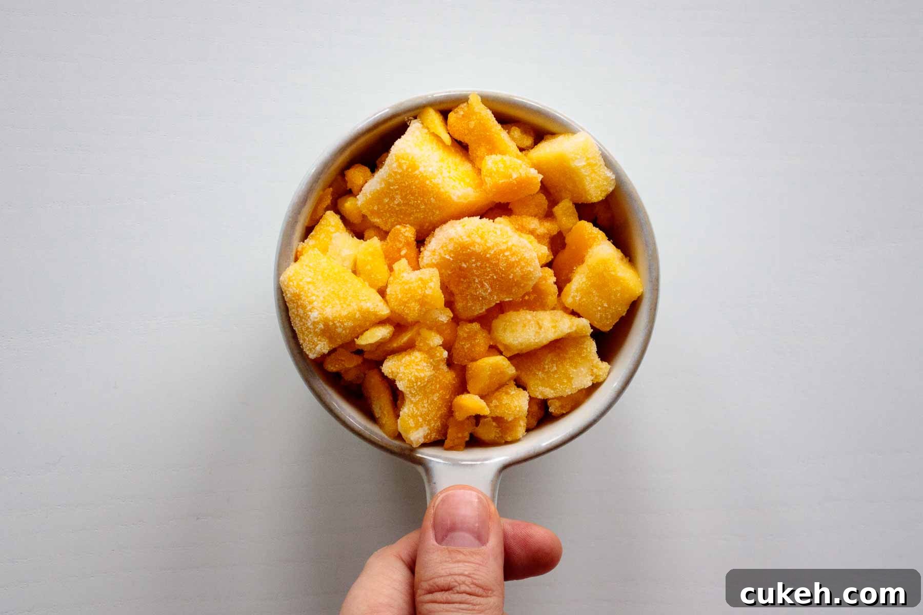 a cup full of frozen mango