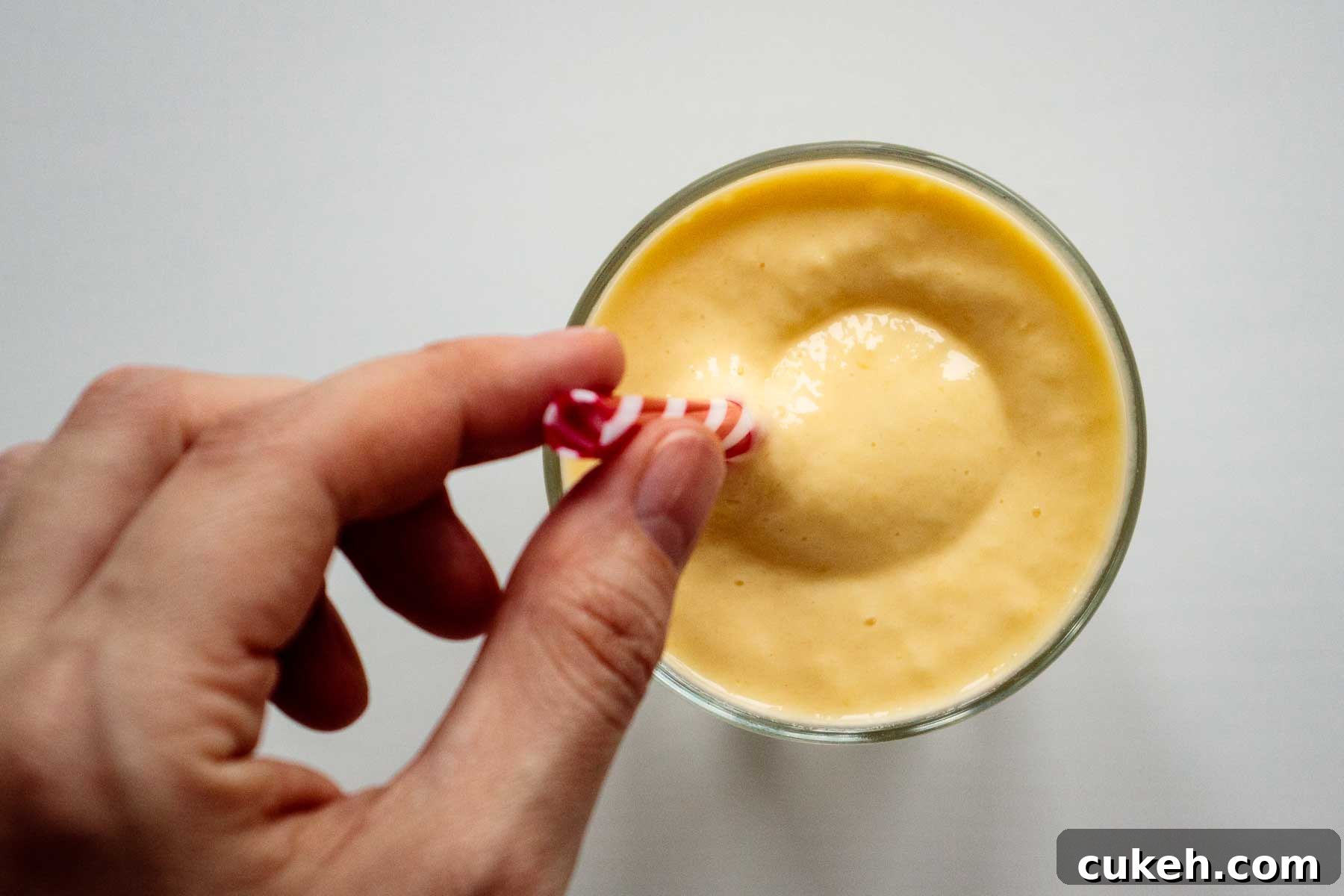 flat lay of smoothie with hand holding a reusable straw