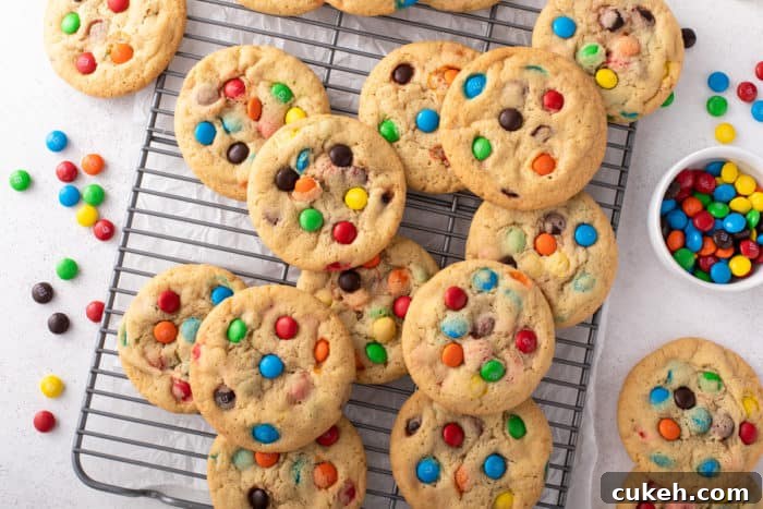 M&M cookies arranged on a wire cooling rack to cool.