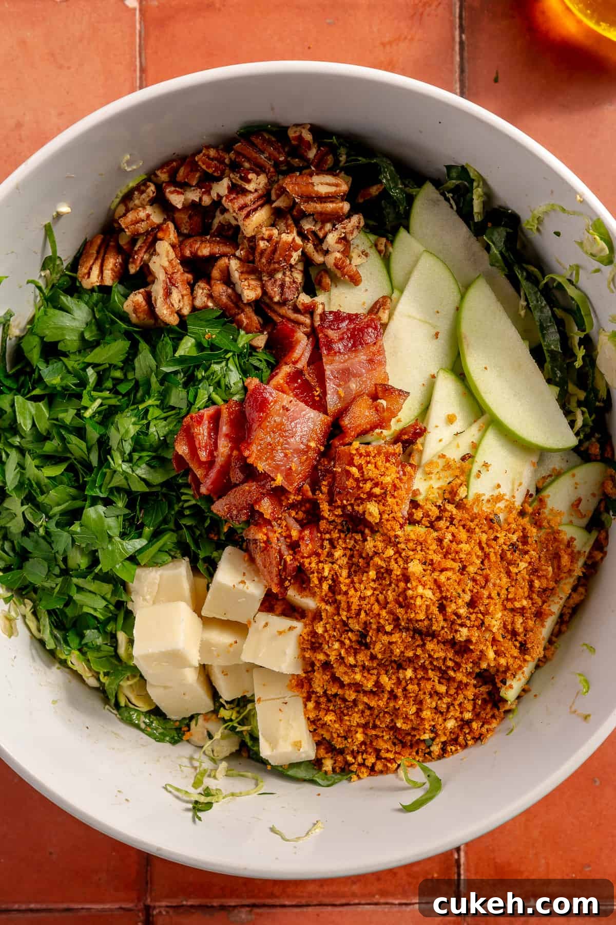 Salad with ingredients all divided on top of the kale.