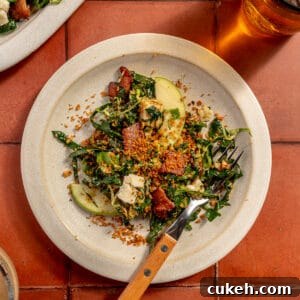 Bacon Brussels Crunch Salad on white plate. Platter peeking in.