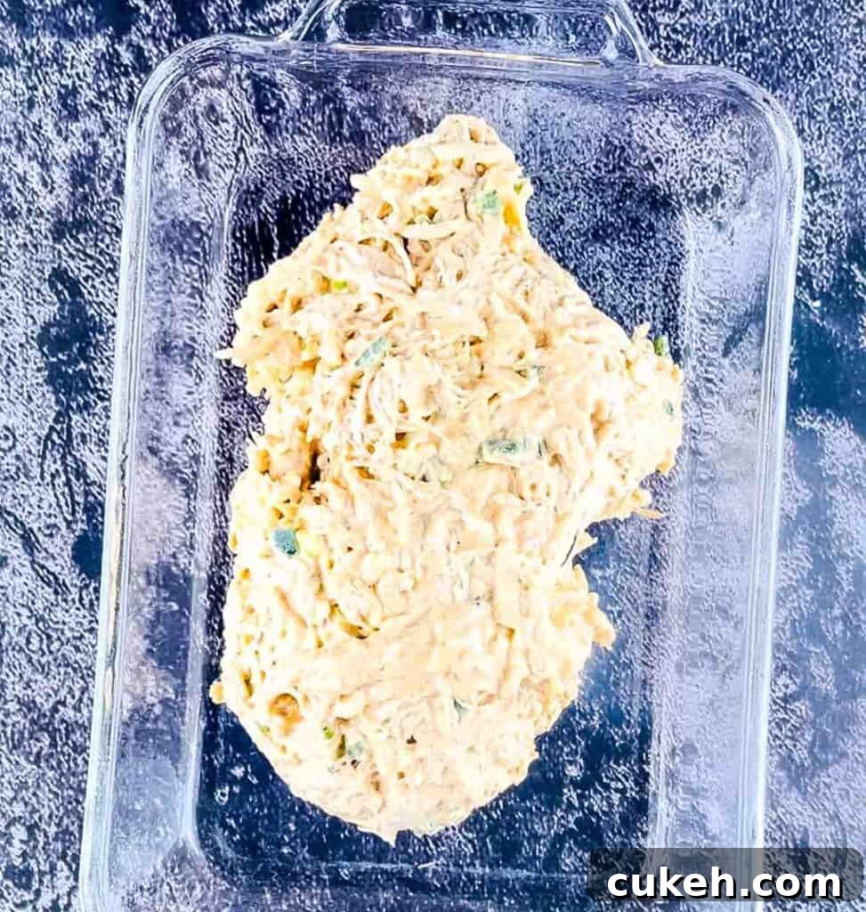 Buffalo Chicken Dip without Cream Cheese — Tangy, Cheesy Recipe 8 The buffalo dip mixture transferred to a greased casserole dish.
