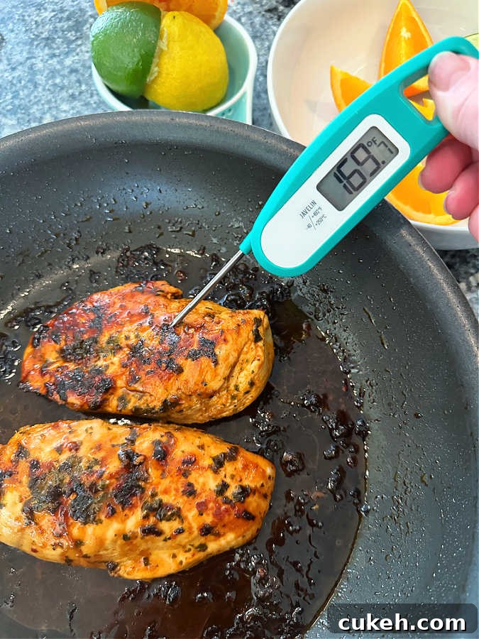 using an instant read thermometer to make sure the citrus marinated chicken is fully cooked