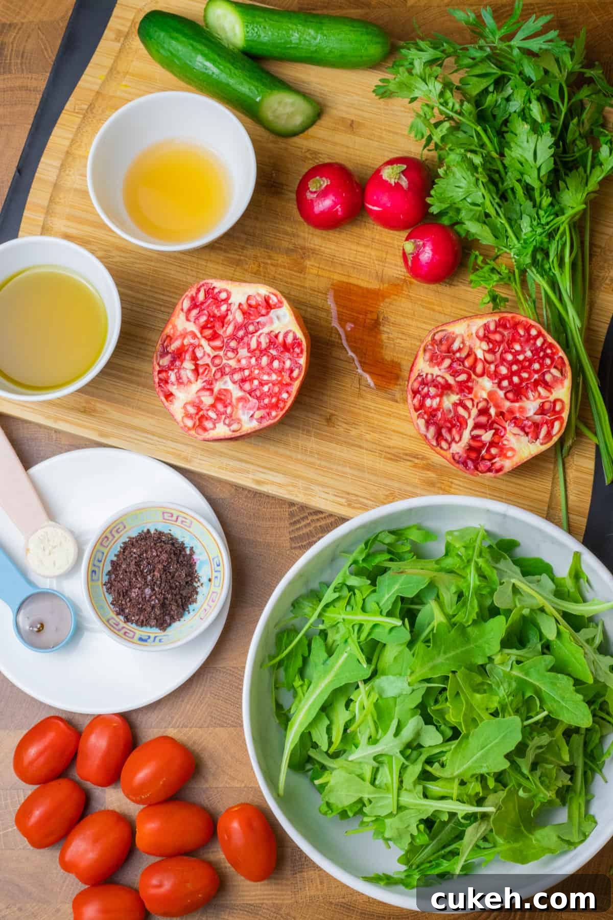 photo showing all of the ingredients for making Middle Eastern rocket salad with sumac and pomegranate.