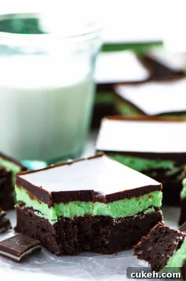 Mint Flourless Brownies topped with mint buttercream and chocolate ganache