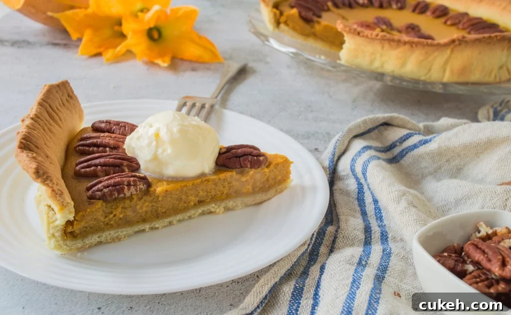 a slice of homemade pumpkin pie with pecans served on a small white plate with silver forks for eating