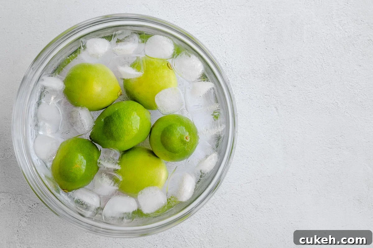 Blanched fresh limes in an ice bath.