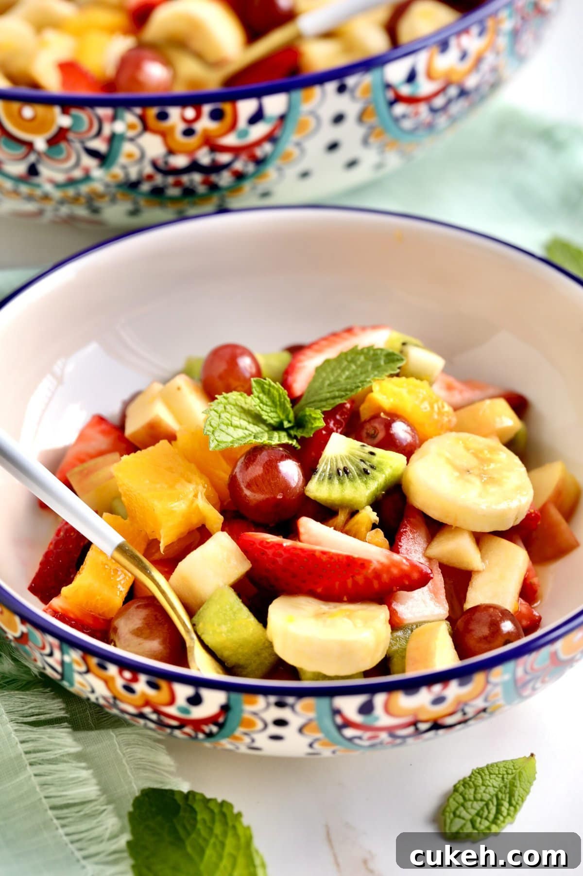 Italian Fruit Salad Recipe (Macedonia di Frutta)- in a bowl with a fork in it ready to eat.