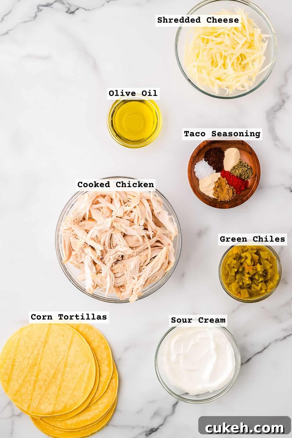 Ingredients for rotisserie chicken tacos on a white countertop.