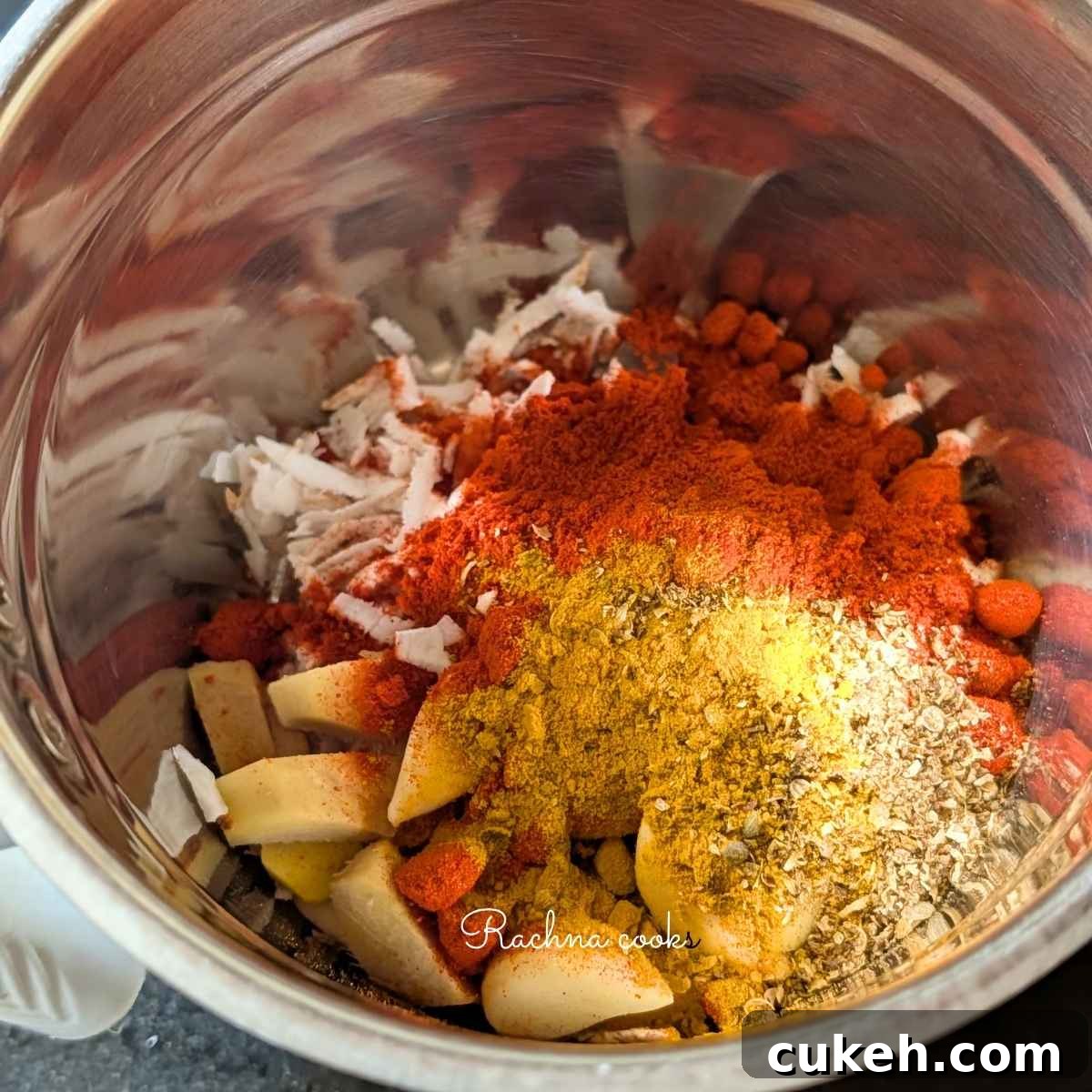 Grated coconut, ginger, garlic, chilli powder, salt, turmeric, and ground coriander in a blender to be blended