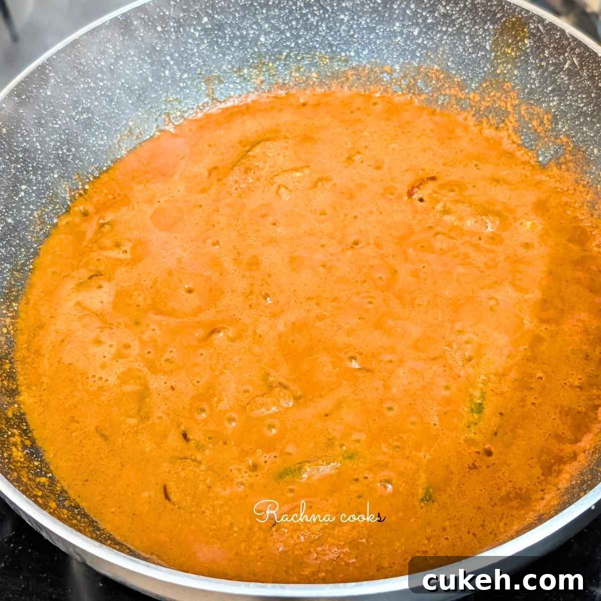 Thick curry paste being cooked in a pan