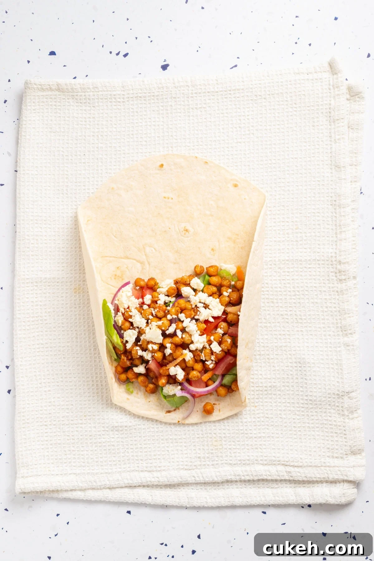 An overhead image of rolling the tortilla wrap.