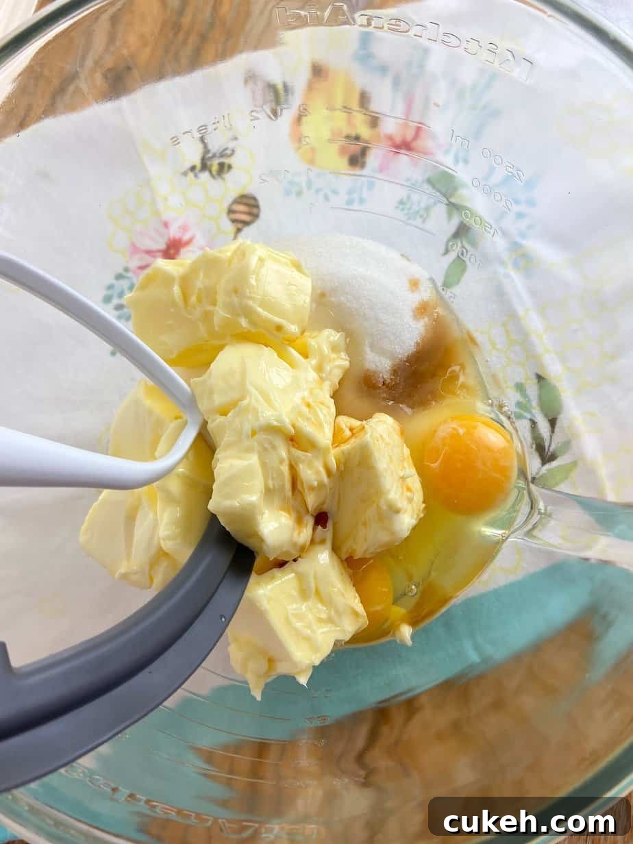Butter, sugar, eggs and vanilla extract in mixing bowl.