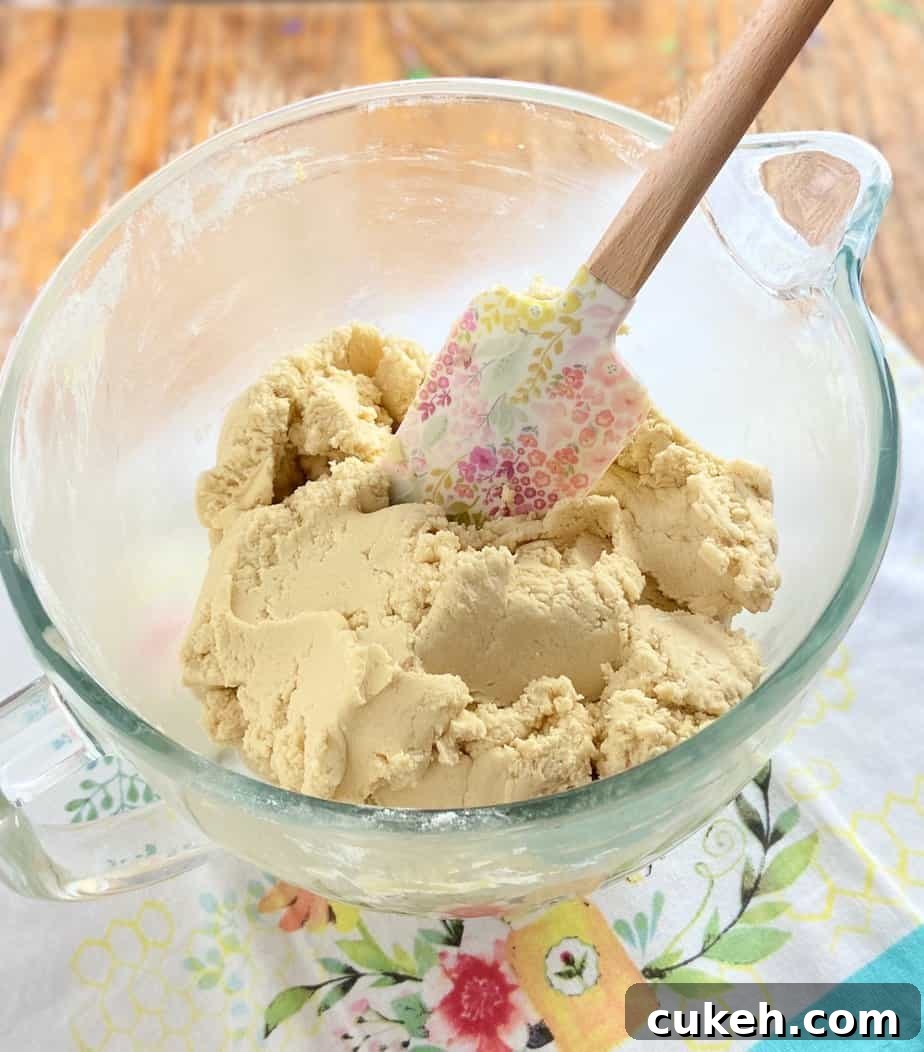 Cookie dough batter in clear mixing bowl.