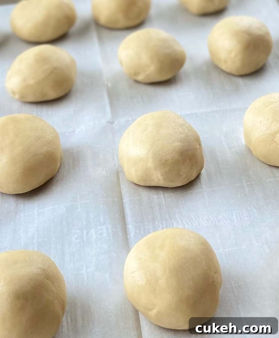 Cookie dough ball on baking sheet.