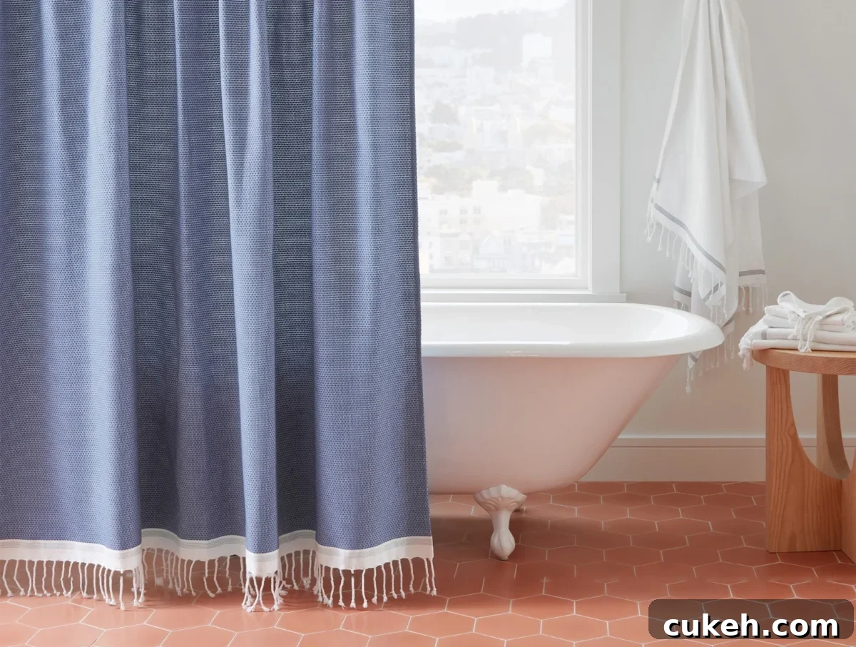 an image of non-toxic shower curtain from Coyuchi in the bathroom with a bathtub behind it