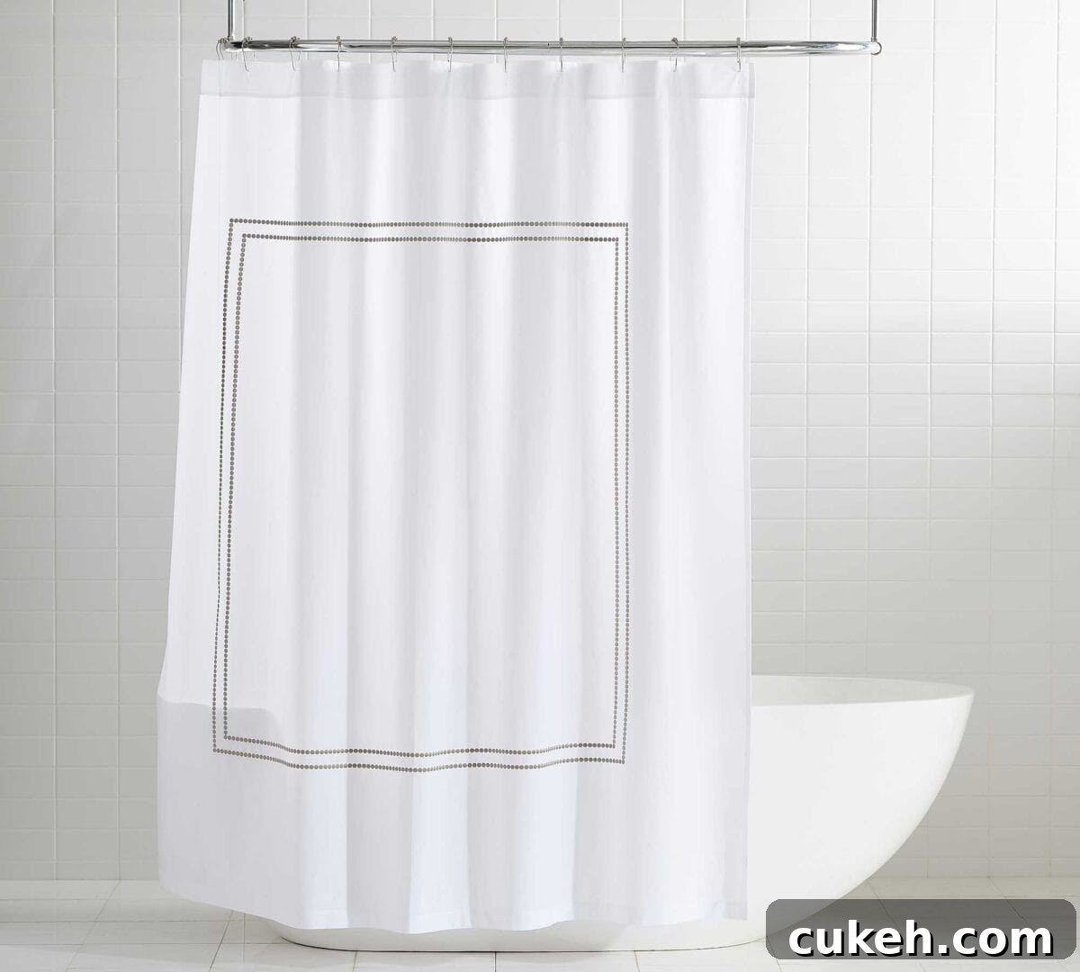 an image of non-toxic white shower curtain from Quiet Town in the bathroom with baththub behind it