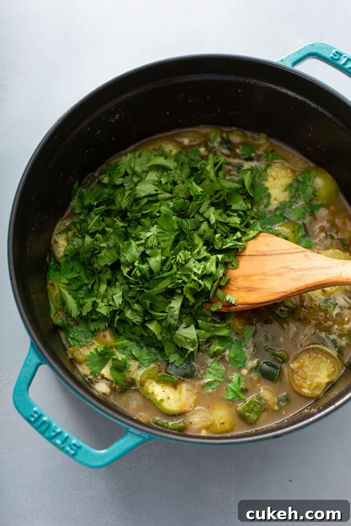 peppers in dutch oven topped with cilantro, lime juice, and broth and then mixed.  